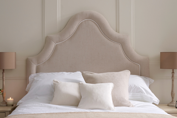 Ornate Curved Border Bryher Headboard upholstered in House Weave Sand with Contrast Piping in Pure Cotton Snow White