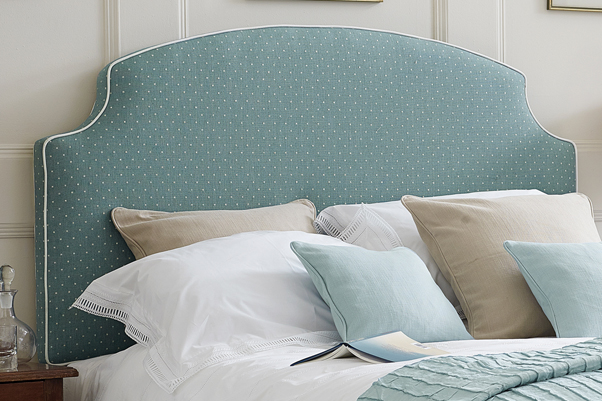 Cottage Style Arched Curve Puffin Headboard upholstered in Linen Spot Wedgwood Blue Fabric with Contrast Piping in Pure Cotton Natural in a Farrow and Ball Cornforth White painted room