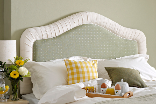 Tresco Classic Curved Pleated Headboard upholstered in Linen Spot Lichen with a contrast border in Pure Cotton Snow in a Farrow and Ball - Ball Green painted room