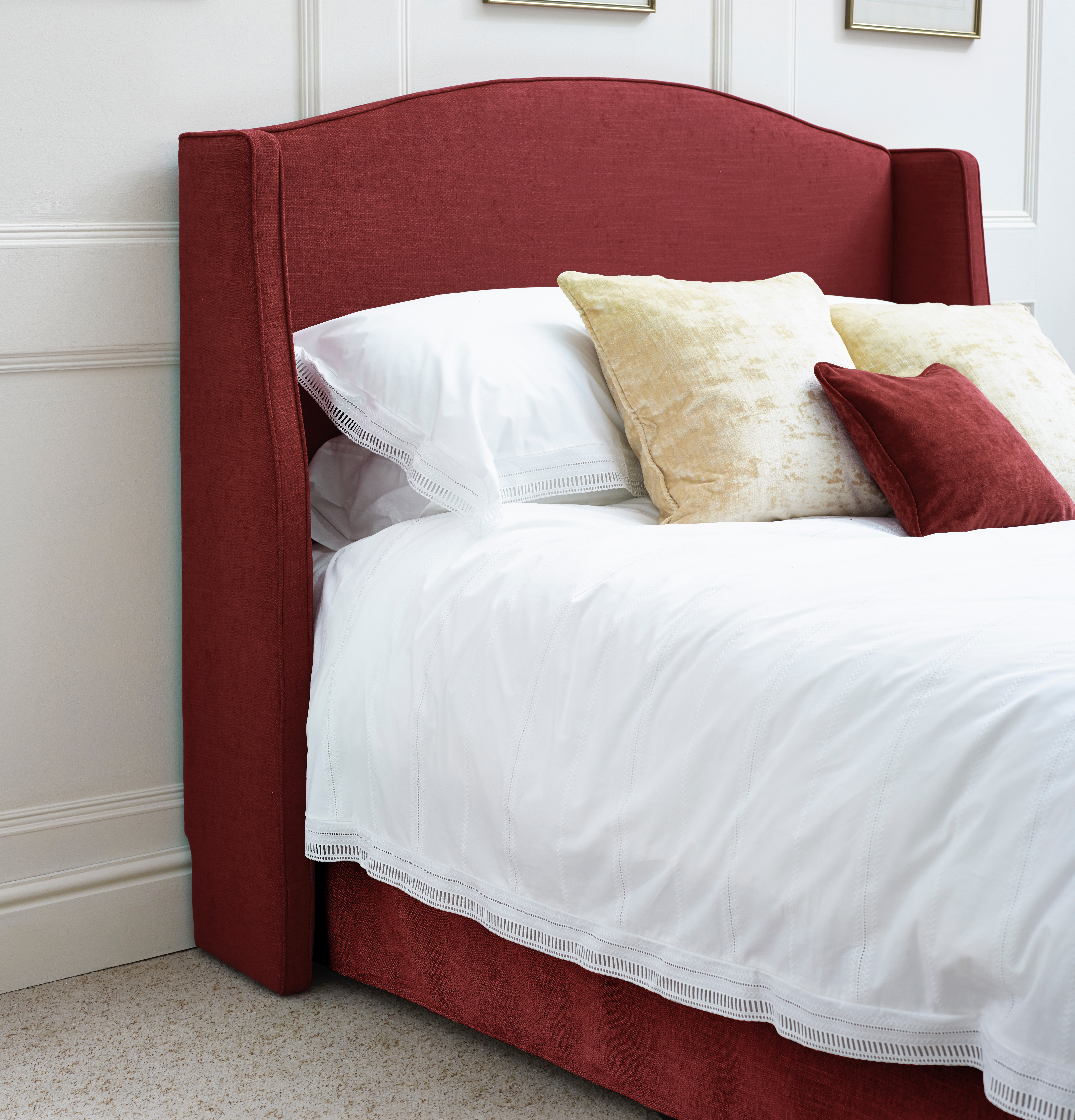Winged Caldey Headboard in House Weave Ruby with skirting board cutout